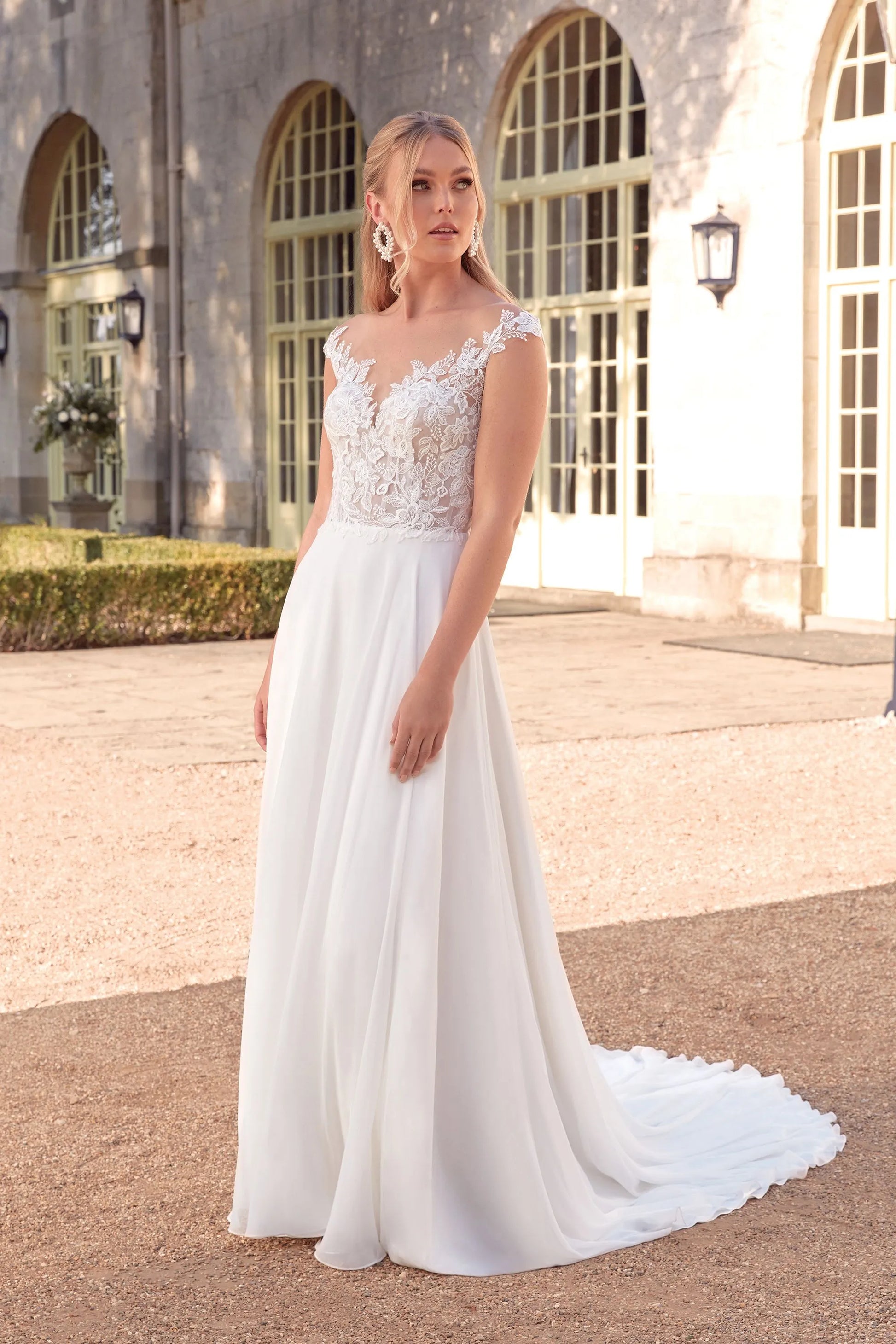 XAYWEAR chiffon wedding dress with lace bodice and flowing skirt worn by a model outdoors