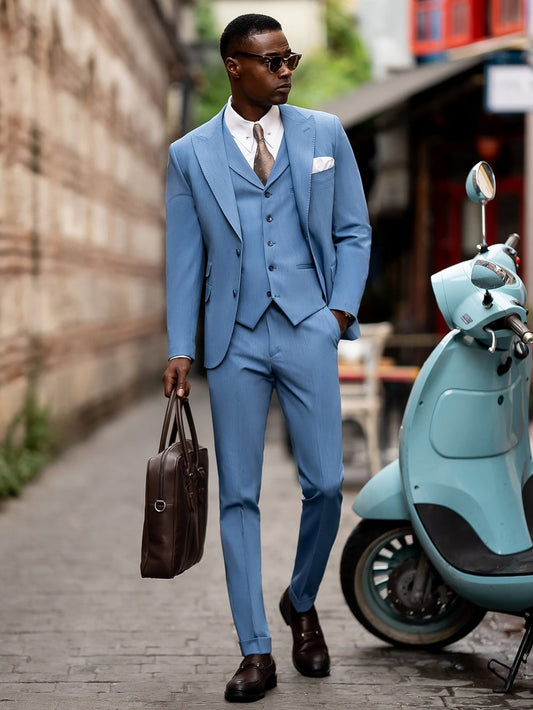 XAYWEAR light blue suit for men with vest and brown leather shoes walking on city street