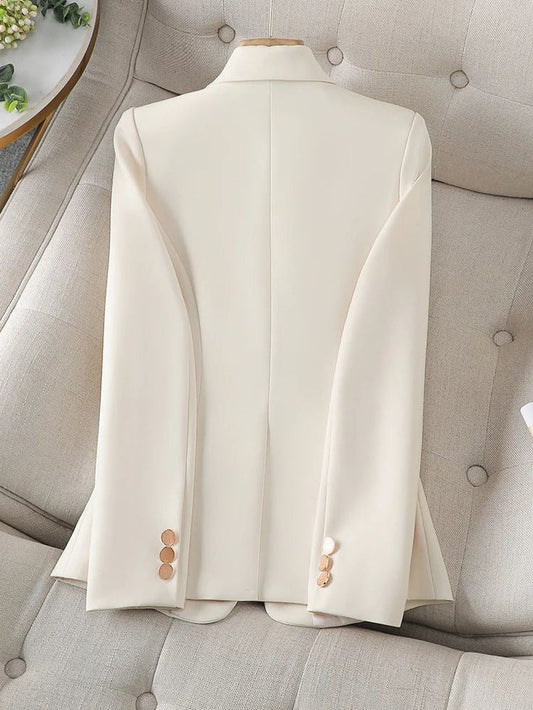 XAYWEAR elegant cream women blazer laid flat on beige cushioned sofa with gold buttons on sleeves