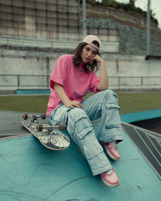 XAYWEAR comfortable streetwear t-shirt in pink, styled with cargo pants and skateboard for a trendy look