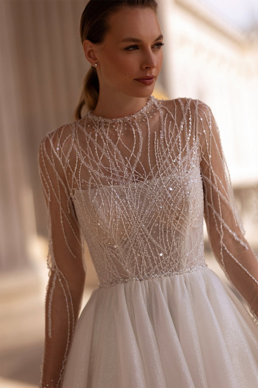 XAYWEAR elegant bridal gown with sheer beaded long sleeves and flowing skirt