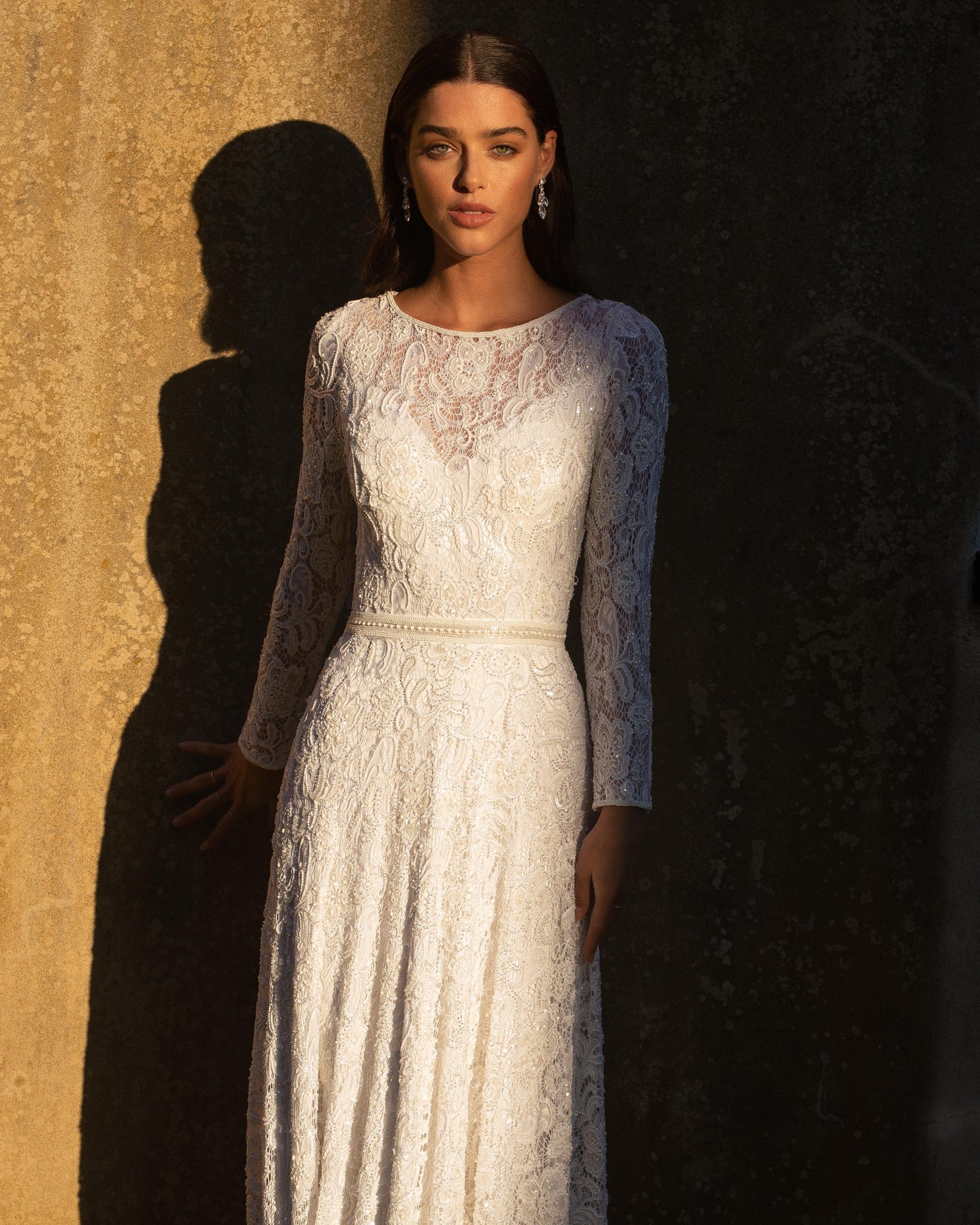 XAYWEAR white bridal gown with long lace sleeves and fitted waist detail