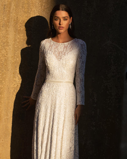 XAYWEAR white bridal gown with long lace sleeves and fitted waist detail