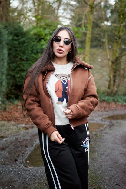 XAYWEAR brown winter jacket with shearling collar worn by woman outdoors in casual outfit