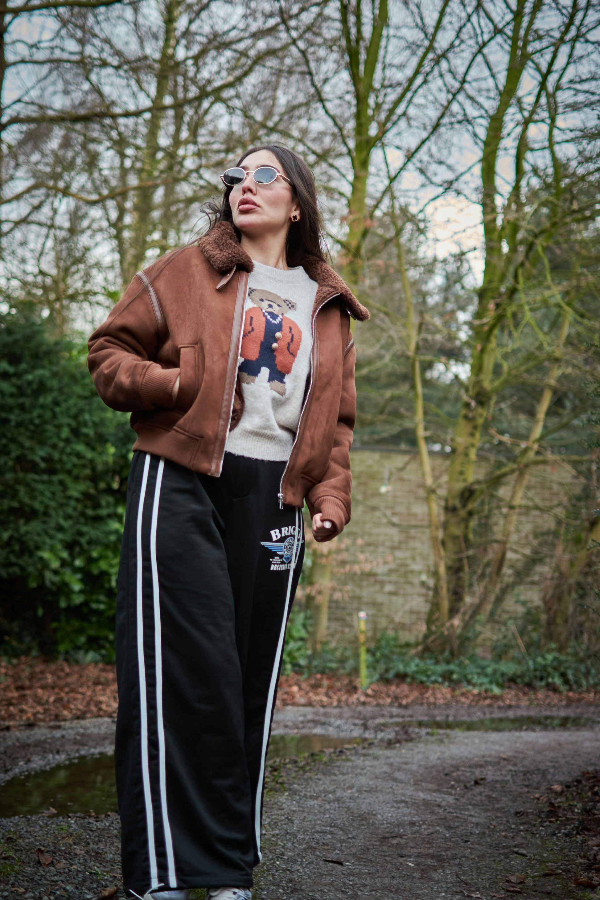 XAYWEAR brown winter jacket with fur collar worn by woman outdoors in casual outfit