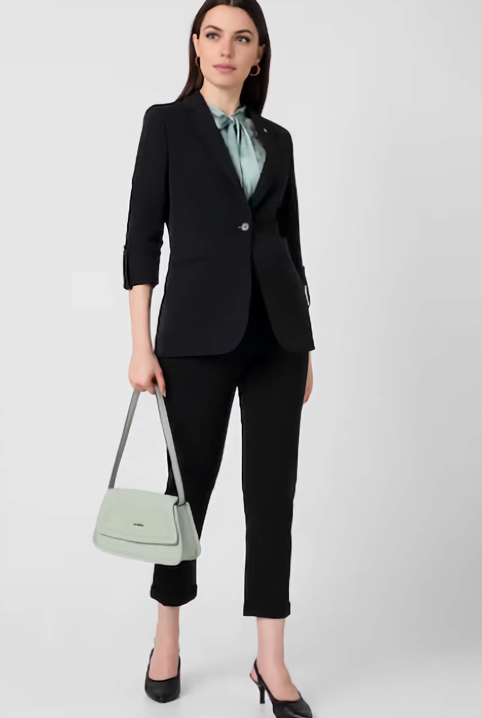 XAYWEAR formal black blazer for women styled with matching pants and green blouse