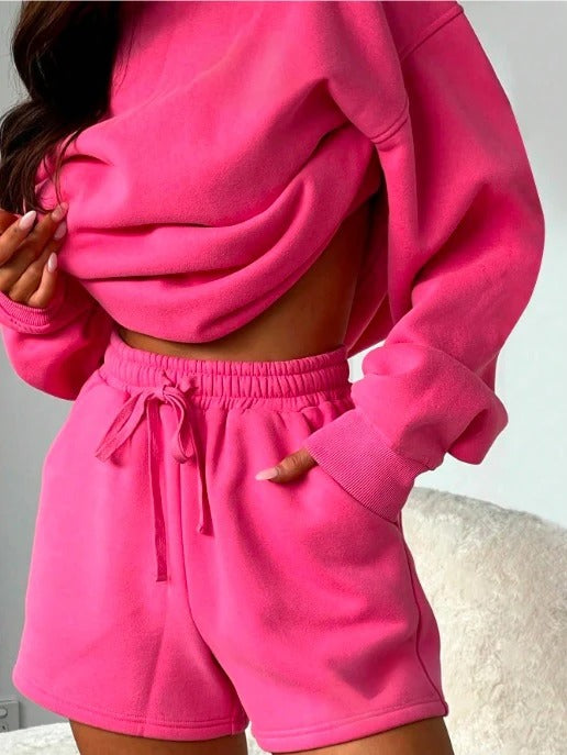 Stylish hot pink loungewear set featuring a cozy oversized top and matching shorts
