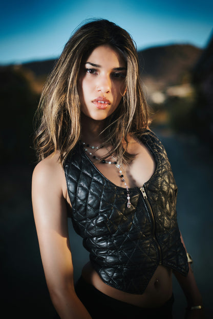 XAYWEAR black quilted leather vest for women with front zipper worn by model outdoors