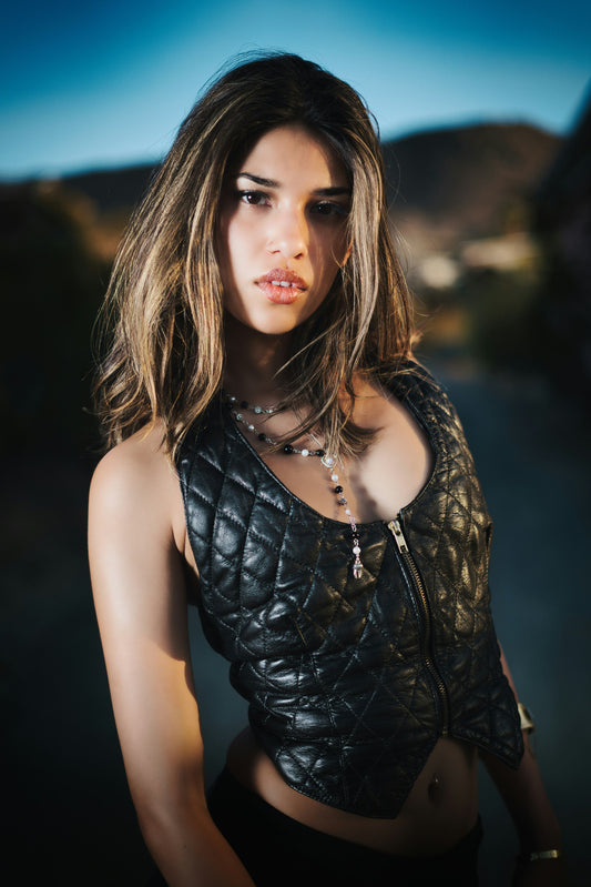XAYWEAR black quilted leather vest for women with front zipper worn by model outdoors