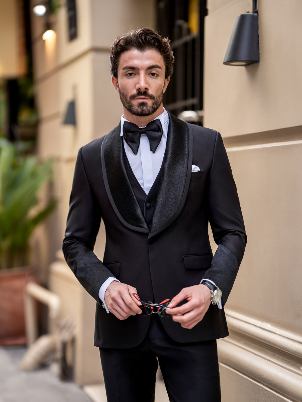 XAYWEAR elegant black three piece suit for men with satin lapels and bow tie worn by male model