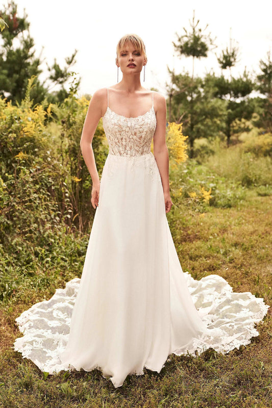 XAYWEAR luxury wedding dress with lace bodice and flowing skirt in outdoor garden setting