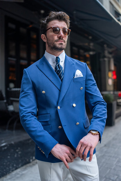 Stylish man wearing a blue men blazer suit by XAYWEAR with white pocket square and patterned tie