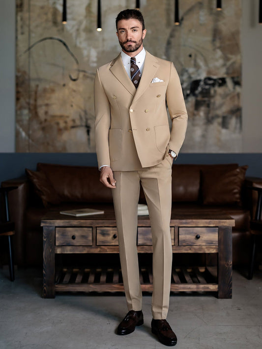 Beige double-breasted suit for men by XAYWEAR styled with a tie and pocket square in a modern living room