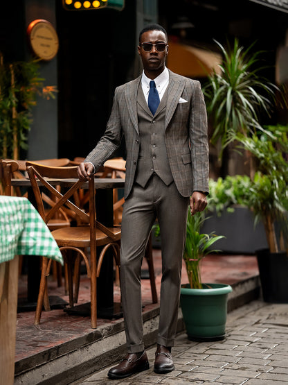 XAYWEAR men suit in brown plaid with white shirt and blue tie worn by man in sunglasses outdoors