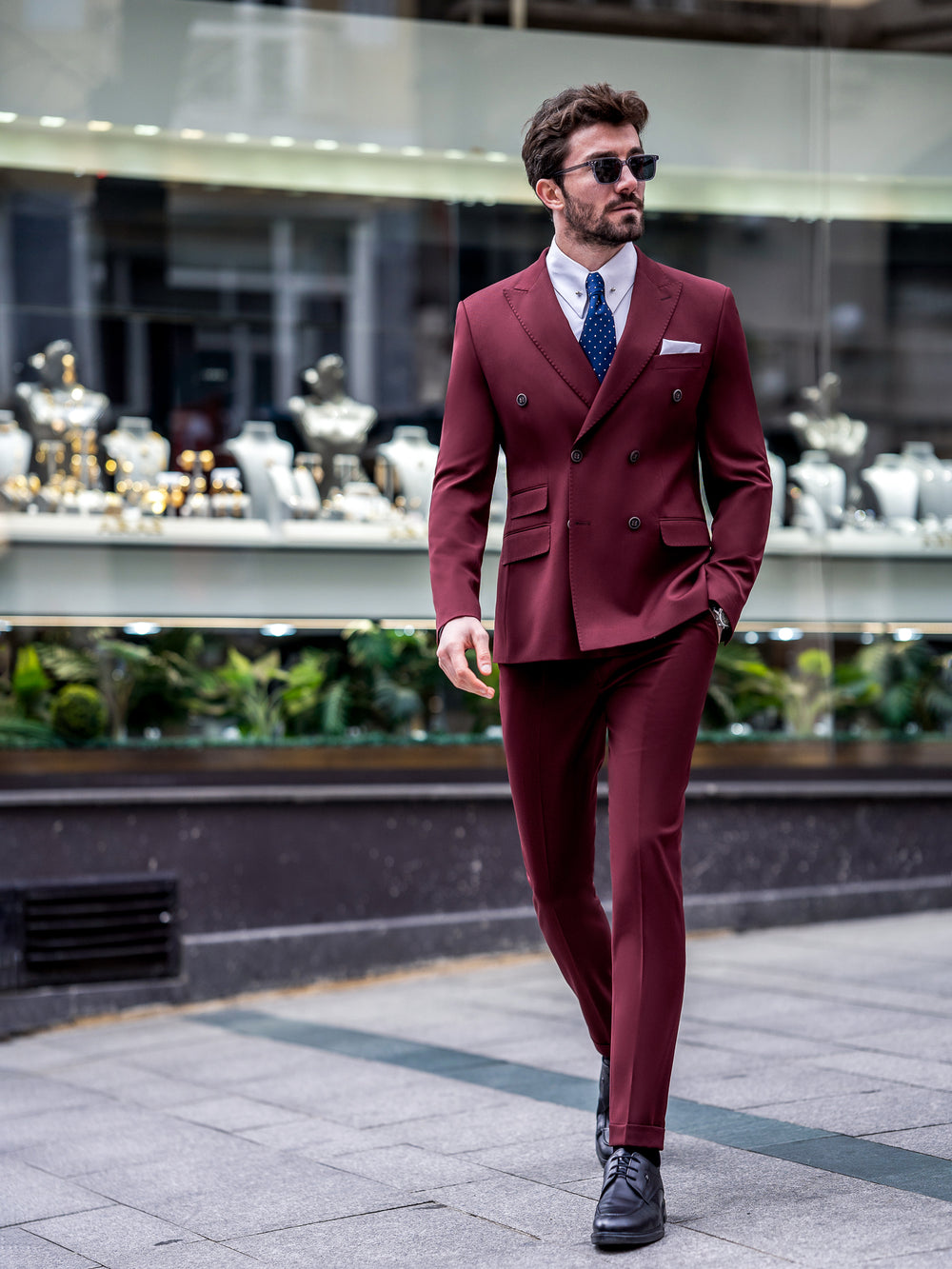 XAYWEAR burgundy double-breasted men suit with navy tie and sunglasses walking in city