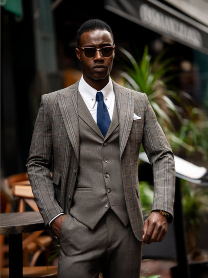 XAYWEAR brown checkered men suit with vest, white shirt, and navy tie worn by man with sunglasses