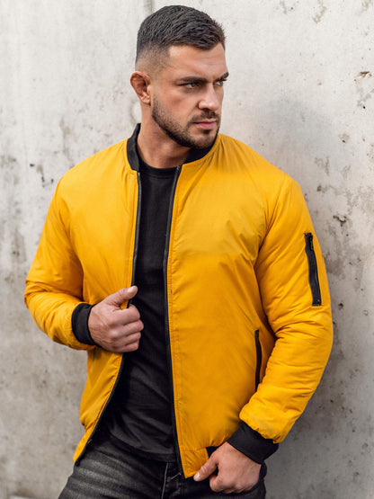 XAYWEAR men yellow jacket bomber style with black zipper and cuffs worn by man against concrete wall