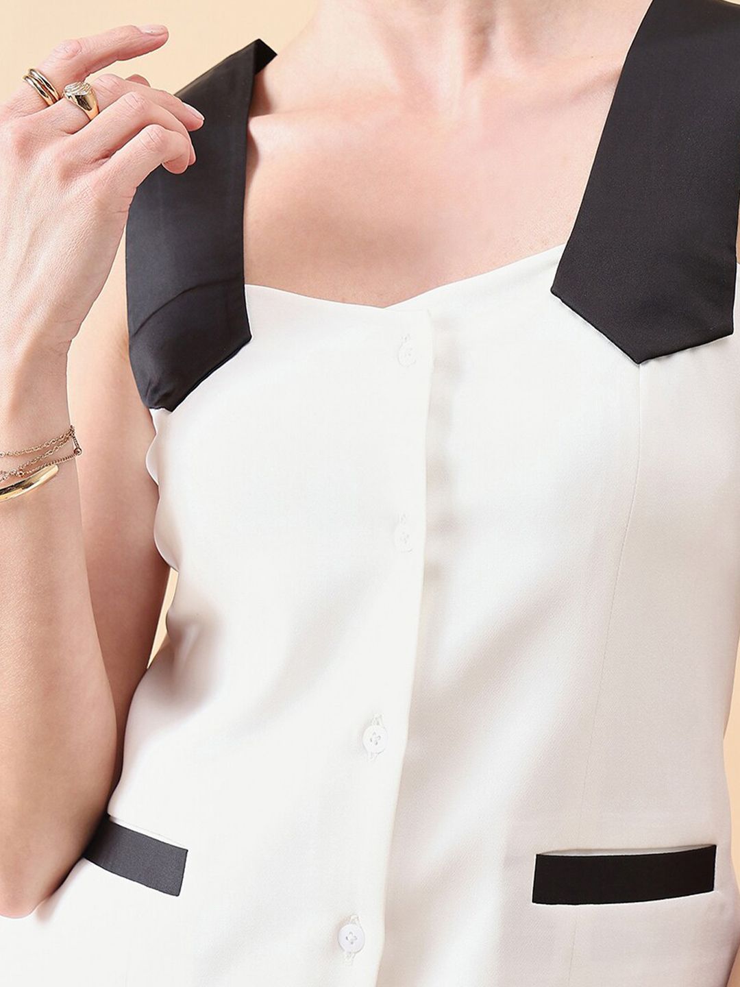 White top with black accents and buttons waistcoat for women by XAYWEAR featuring wide shoulder straps