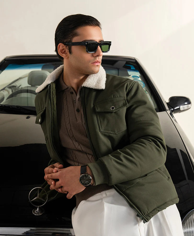 Olive winter jacket for men styled with sunglasses, perfect for a chic winter look