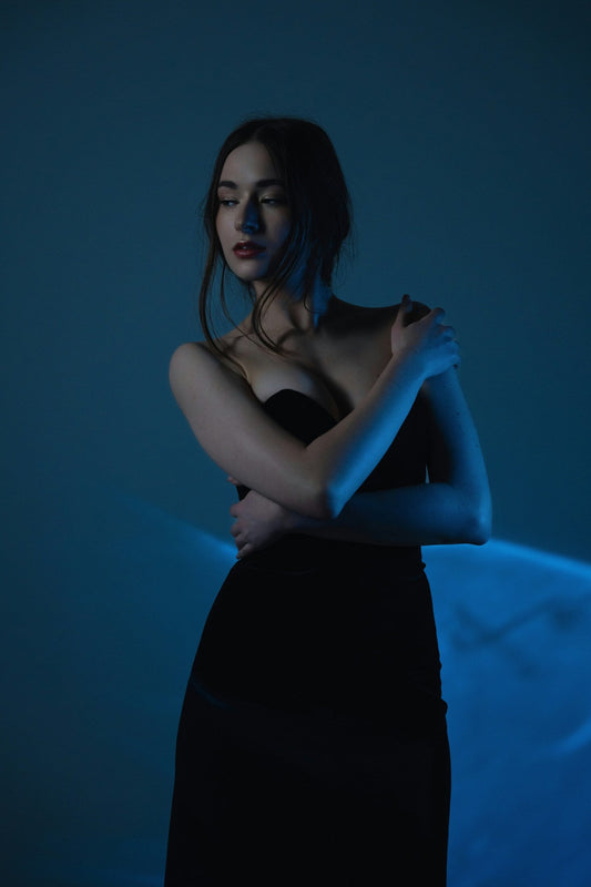 Elegant model wearing a premium black gown with a sleek design and luxurious fabric