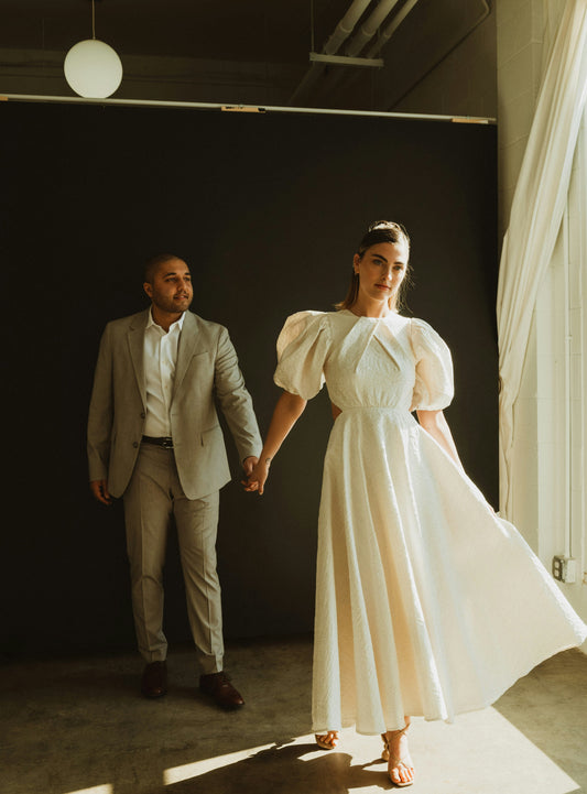 XAYWEAR premium bridal dress with back detail, featuring puff sleeves and a flowing skirt
