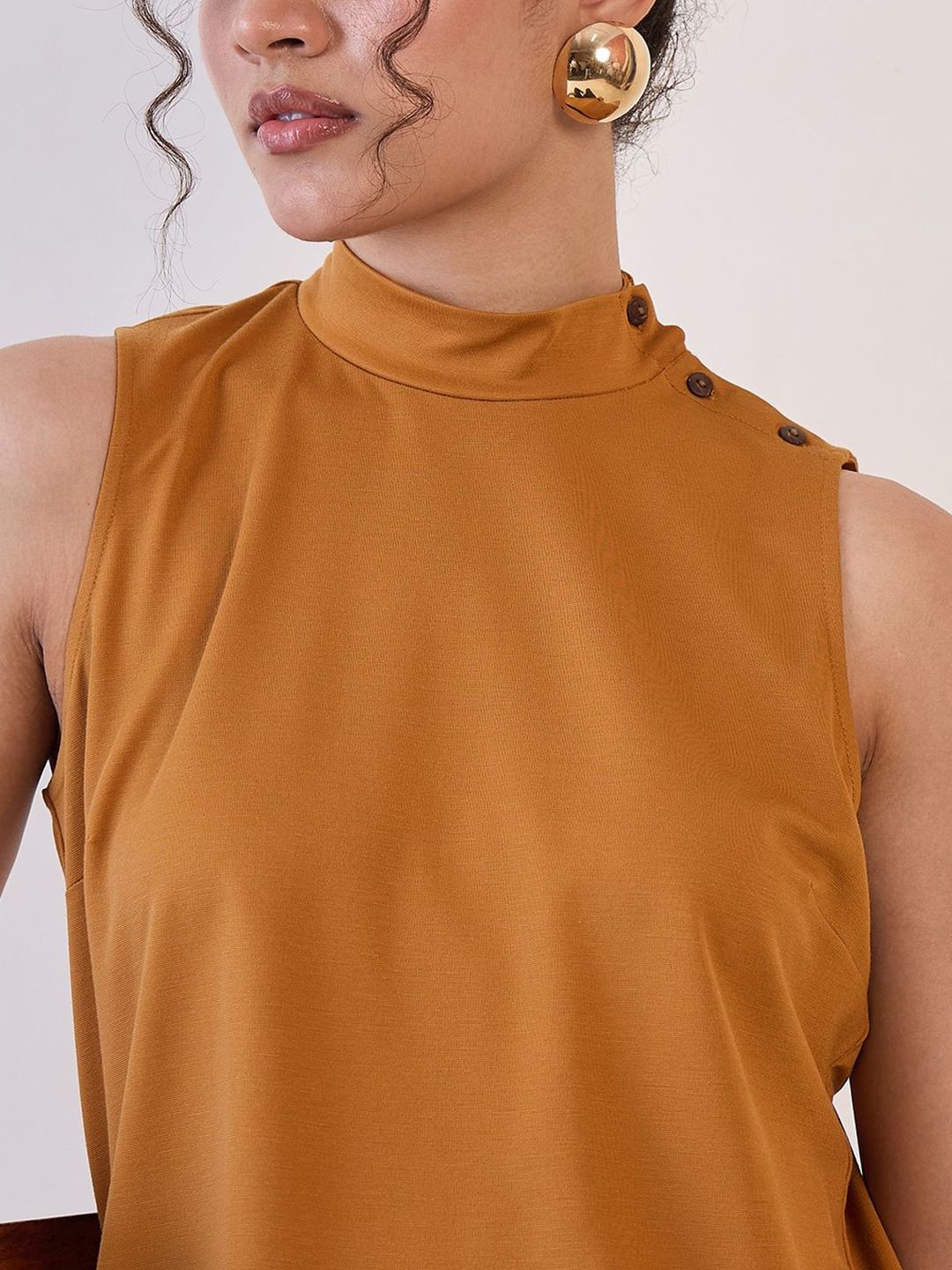 XAYWEAR high neck sleeveless top in mustard with button details and smooth fabric