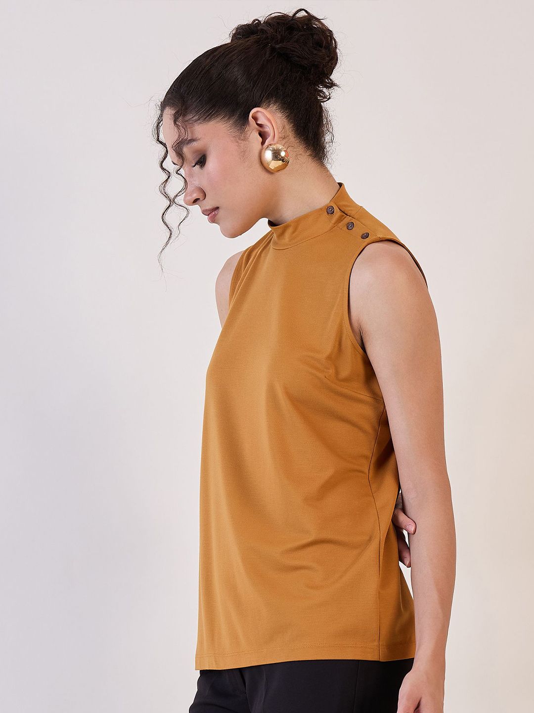XAYWEAR high neck sleeveless top in mustard color featuring button details on the shoulder