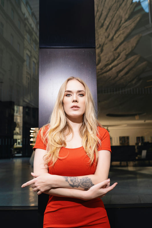 Stylish woman in a Premium Red Bodycon Dress posing confidently outdoors