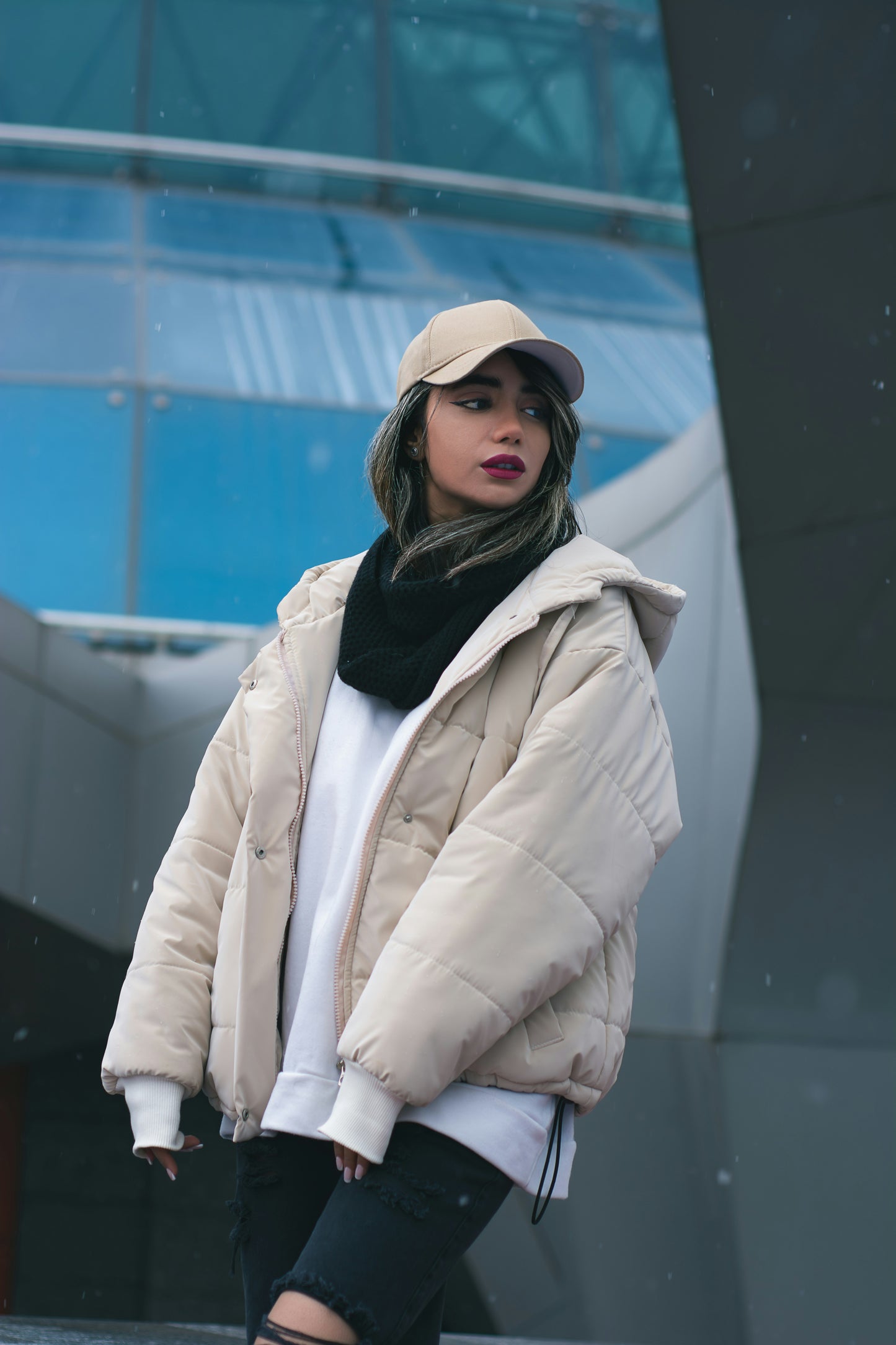 XAYWEAR beige puffer jacket for women with hood, styled with black scarf and beige cap