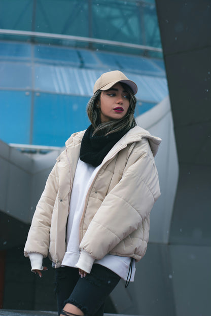 XAYWEAR beige puffer jacket for women with hood, styled with black scarf and beige cap