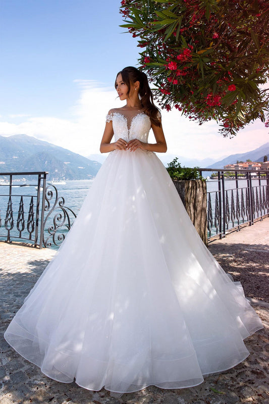 XAYWEAR elegant ballgown wedding dress with lace bodice and full tulle skirt by the lakeside