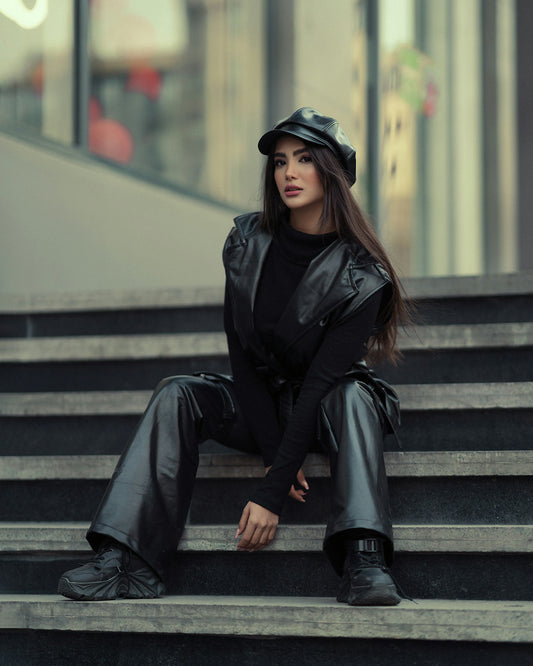 Sleek black leather vest blazer styled with matching pants for a chic urban look