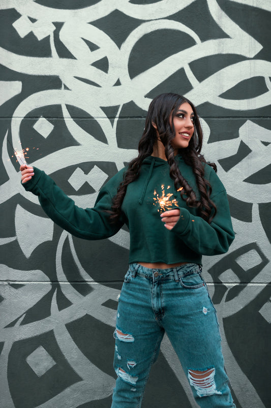 Stylish cropped hoodie for women in dark green paired with light blue distressed jeans