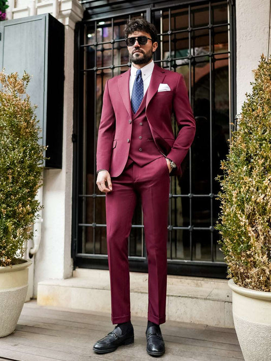 XAYWEAR burgundy suit for men with double-breasted vest, white shirt, and blue tie styled outdoors