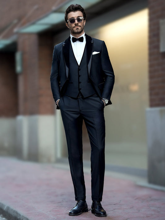 XAYWEAR elegant three piece suit worn by man with bow tie and sunglasses standing outdoors