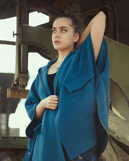 XAYWEAR blue cape jacket for women with large pockets worn by a woman in an industrial setting