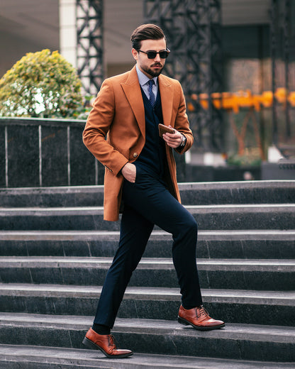 Stylish coat for men by XAYWEAR in camel color worn over formal suit with leather shoes