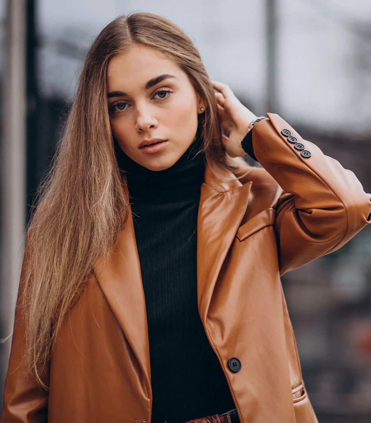 XAYWEAR faux leather jacket for women in brown worn over black turtleneck sweater