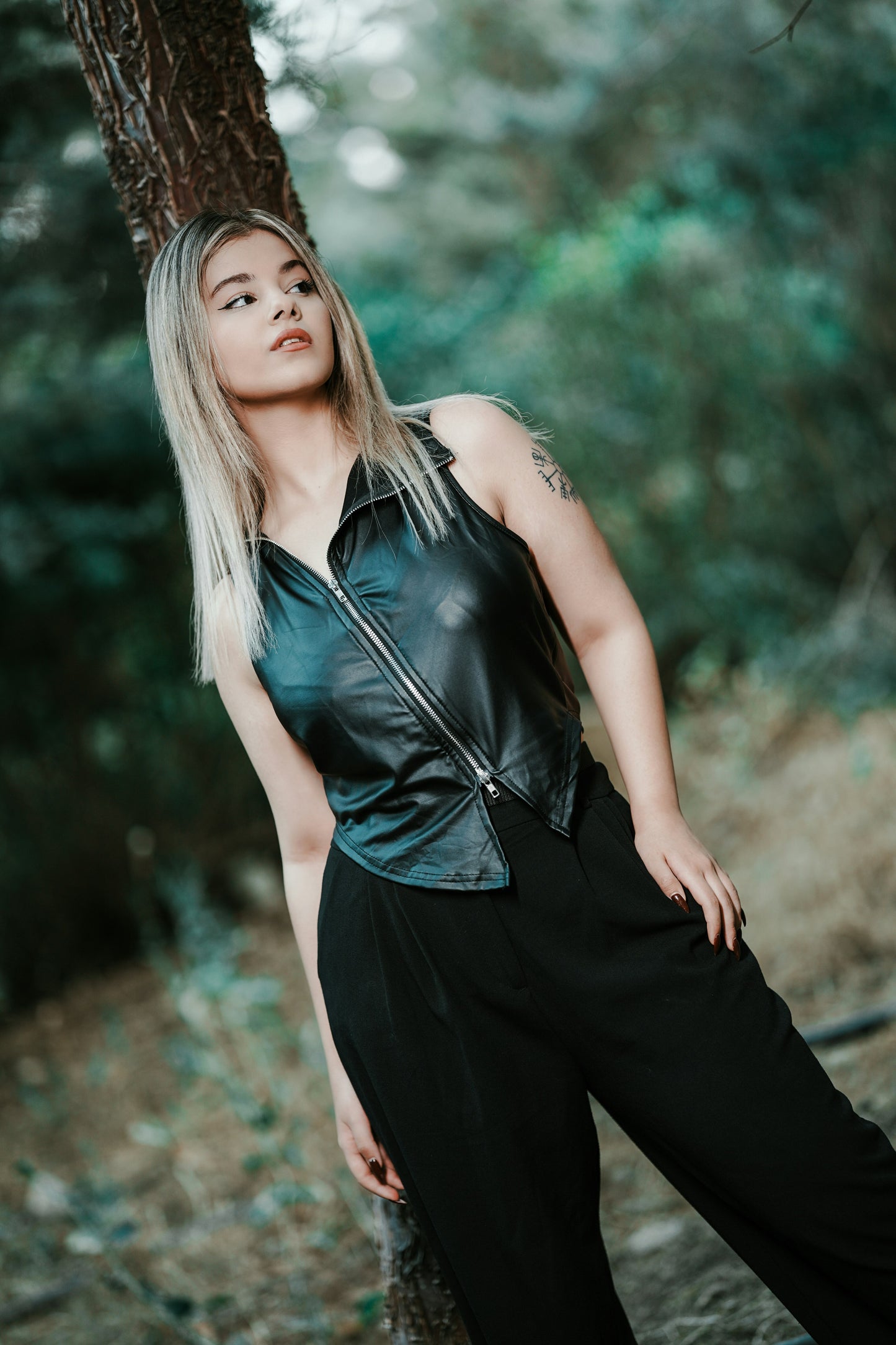 XAYWEAR black leather vest for women with front zipper and sleeveless design styled outdoors