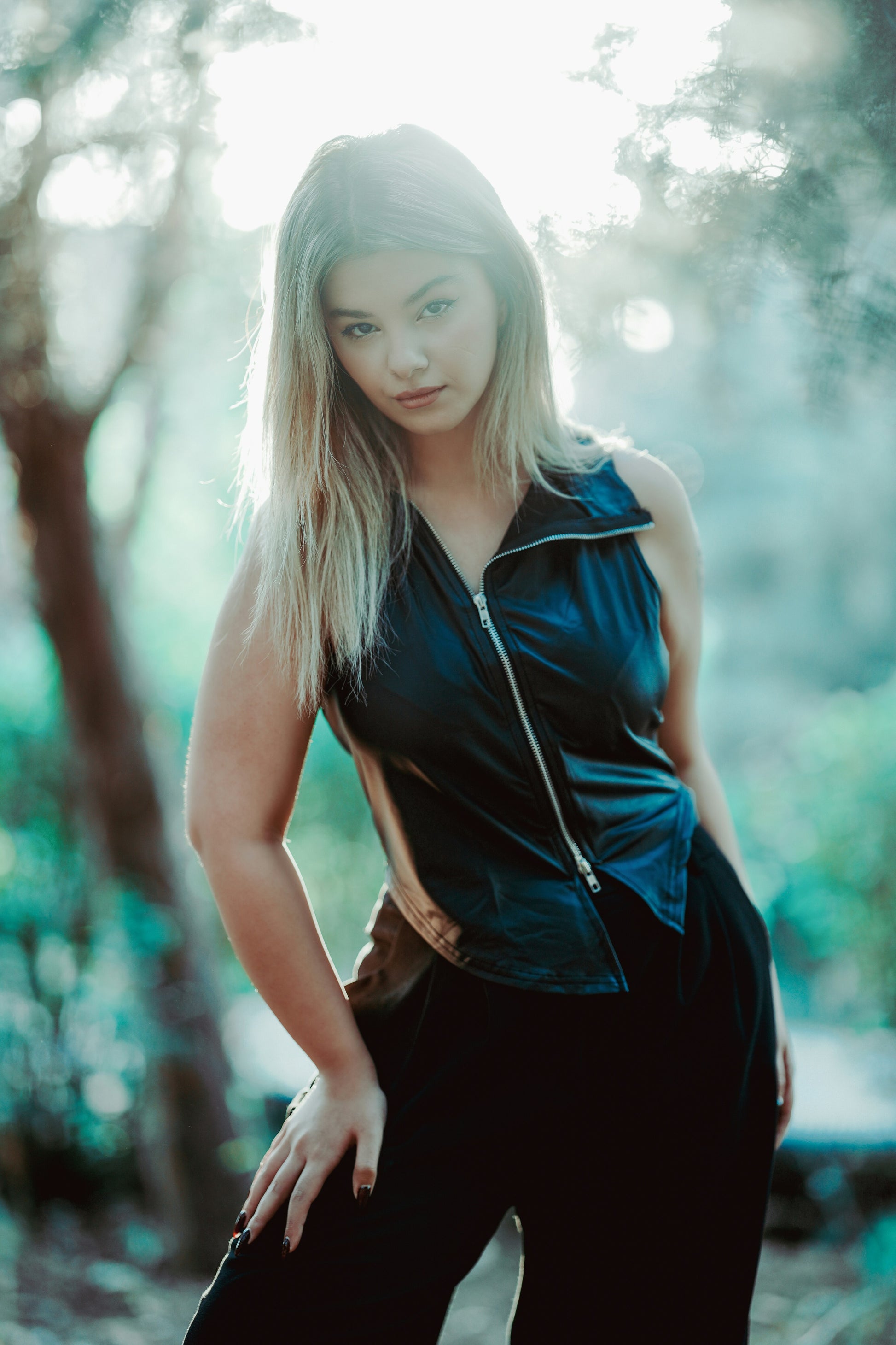 XAYWEAR black leather vest for women with front zipper worn by model outdoors