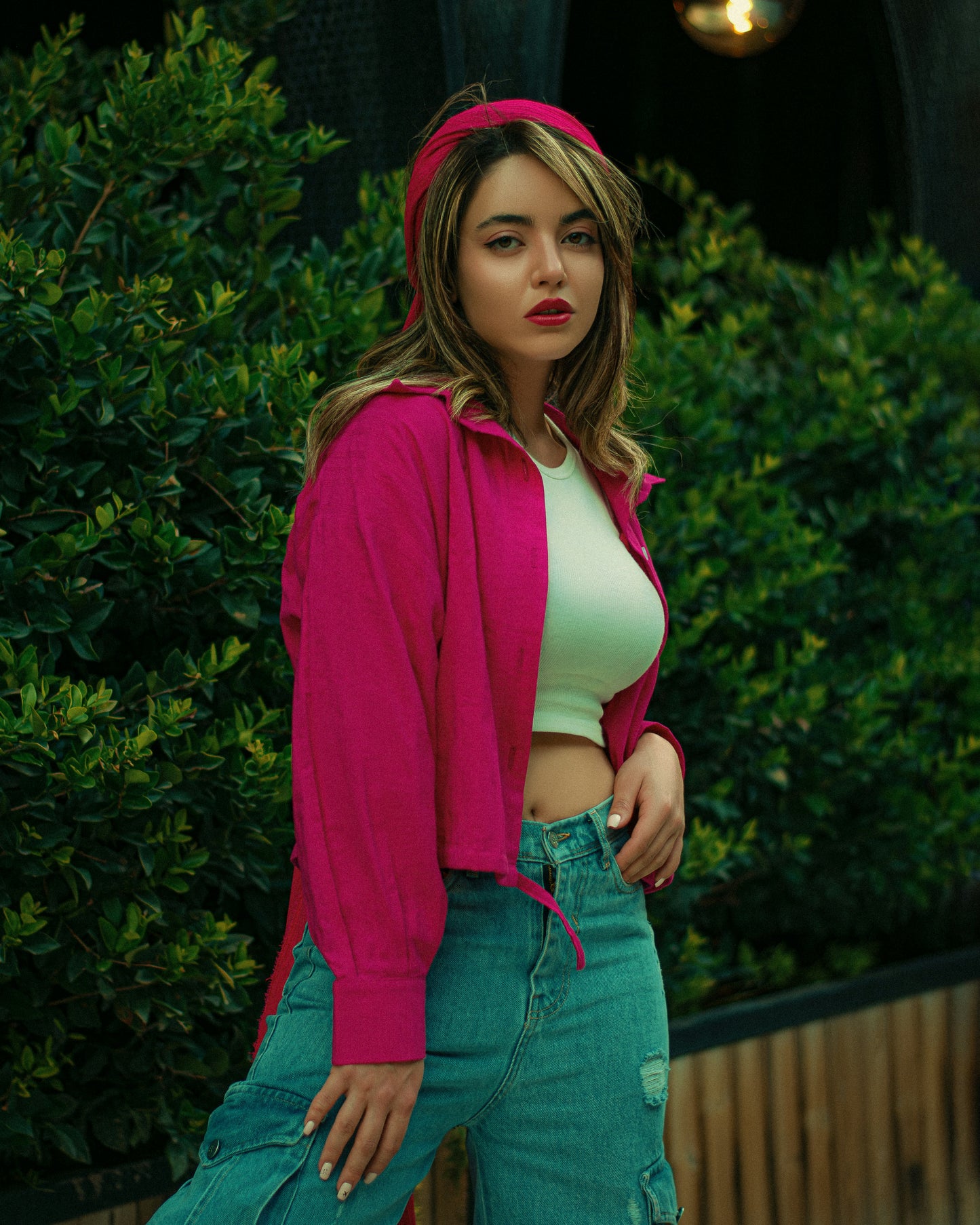 XAYWEAR pink jacket for women styled with white crop top and green jeans outdoors