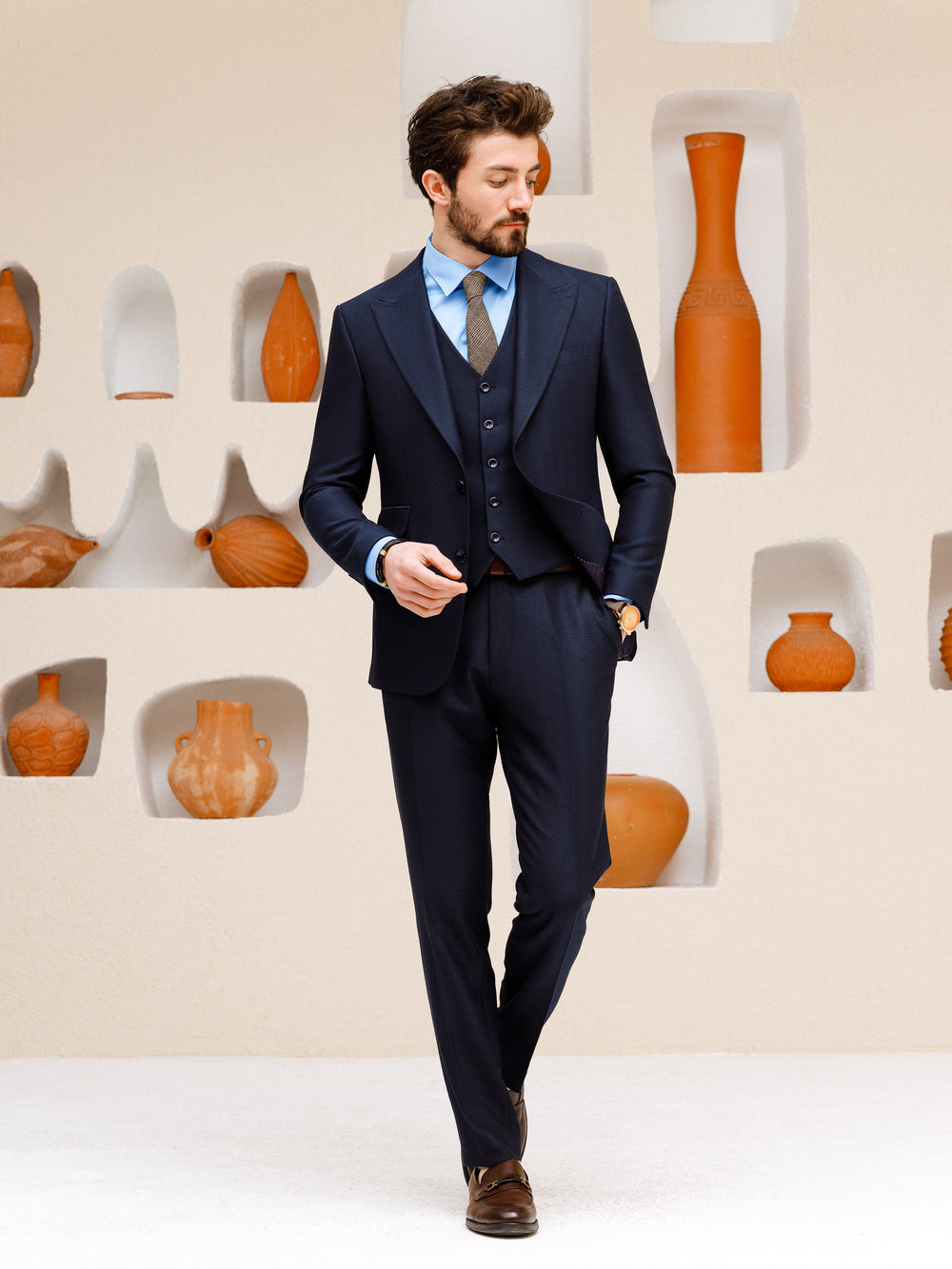 XAYWEAR navy suit set for men featuring a blazer, vest, and trousers styled with a blue shirt and brown shoes