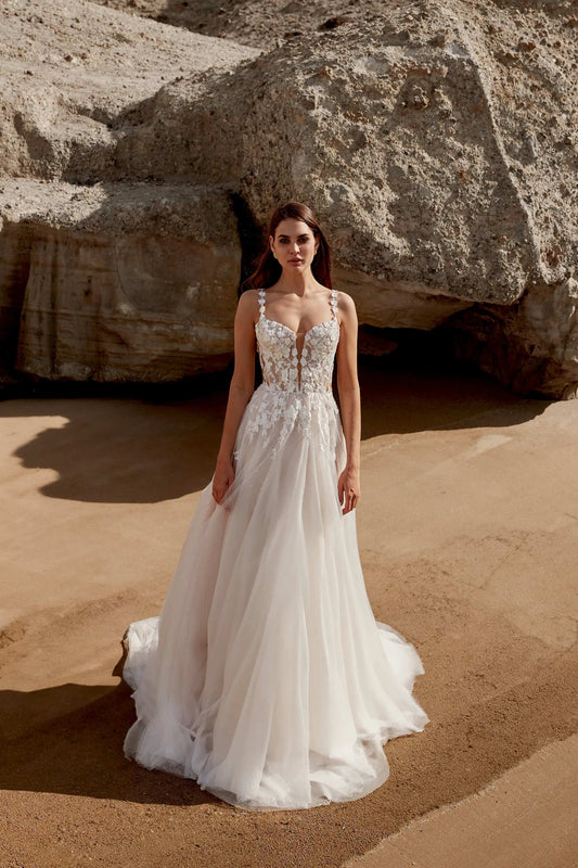 XAYWEAR elegant wedding dress with floral lace bodice and flowing tulle skirt on model outdoors