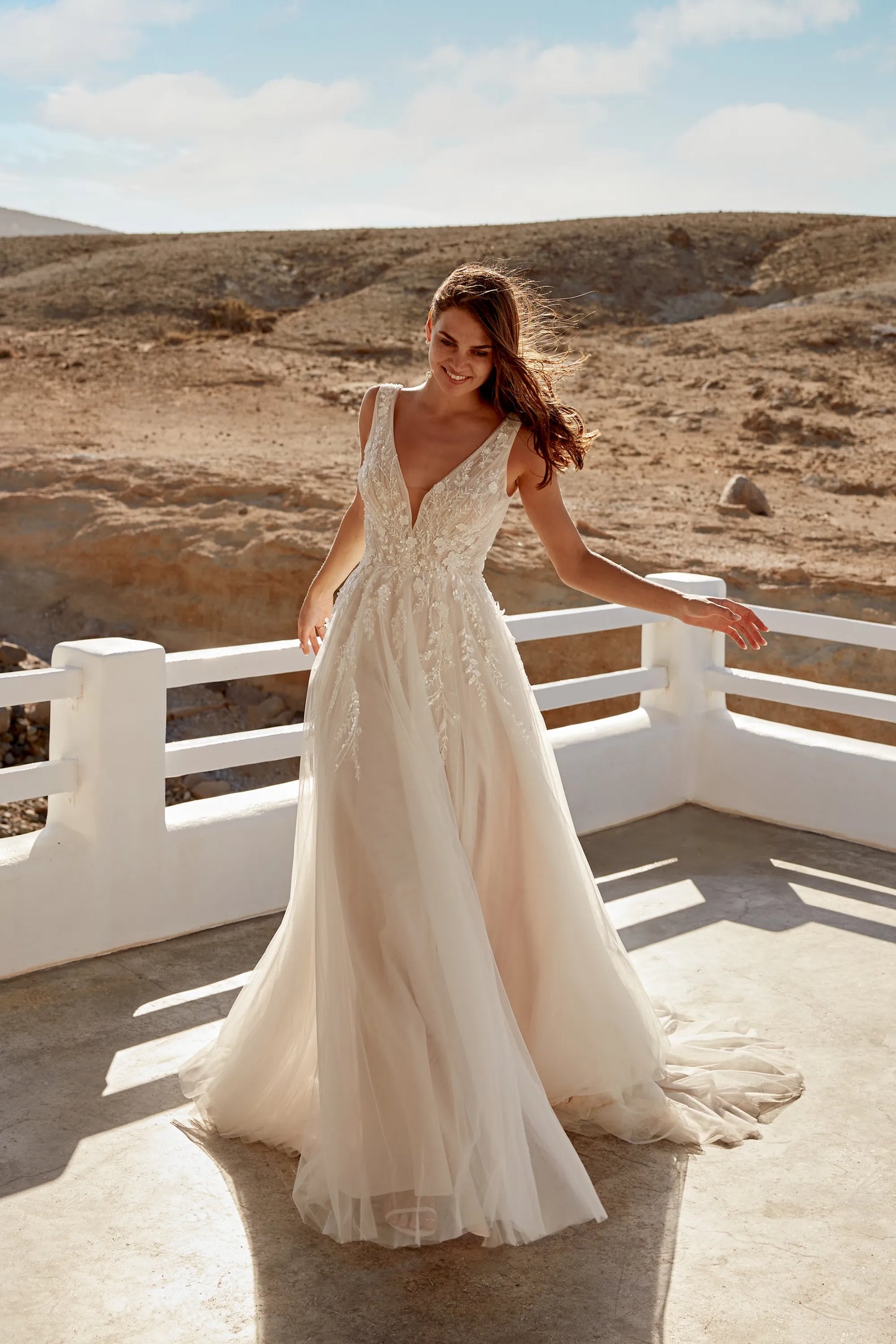 XAYWEAR elegant wedding dress with deep V neckline and lace detailing in outdoor desert setting