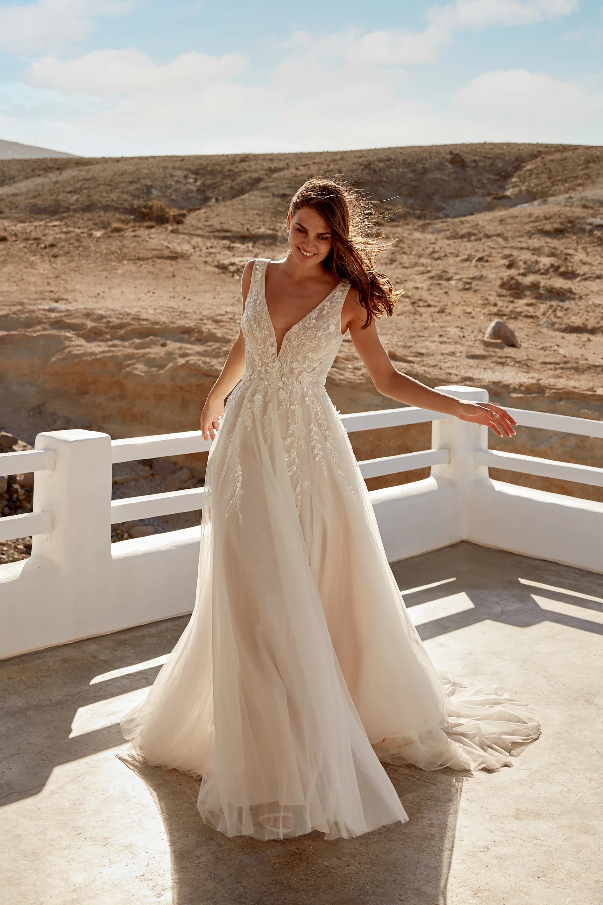 XAYWEAR elegant wedding dress with deep V neckline and lace detailing in outdoor desert setting