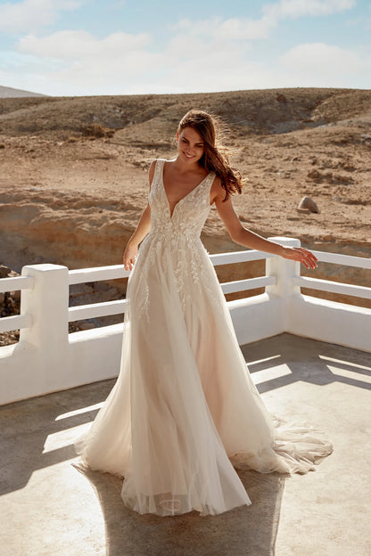 XAYWEAR elegant wedding dress with deep V neckline and lace detailing in outdoor desert setting