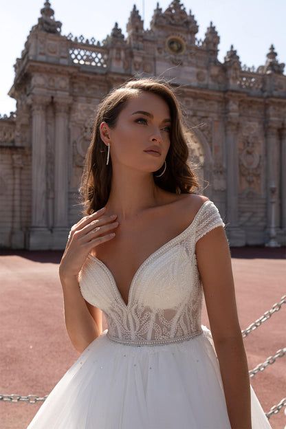 XAYWEAR elegant wedding dress with off-shoulder neckline and intricate lace details on bodice