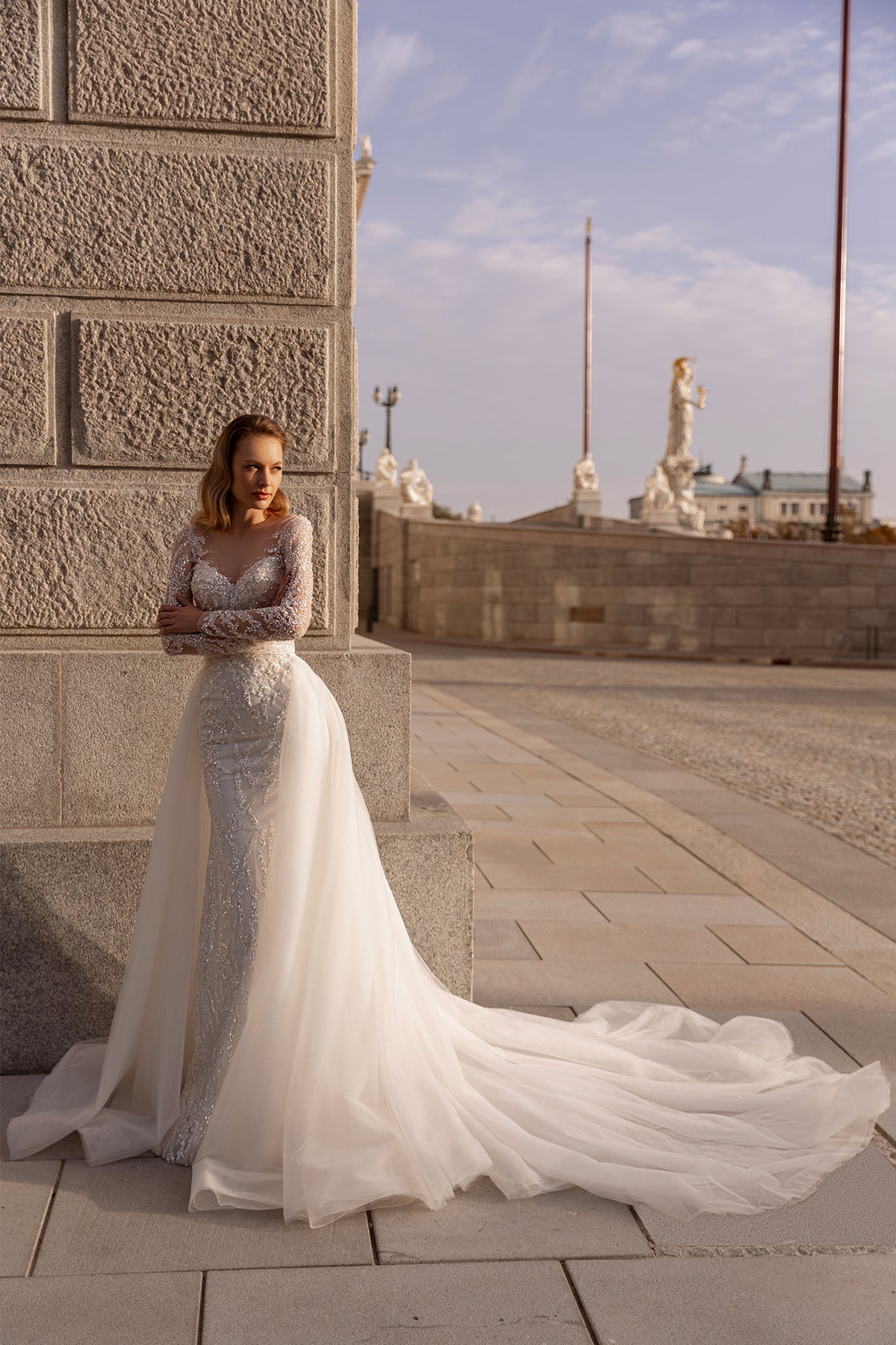 XAYWEAR elegant wedding dress with lace bodice and long flowing train worn outdoors