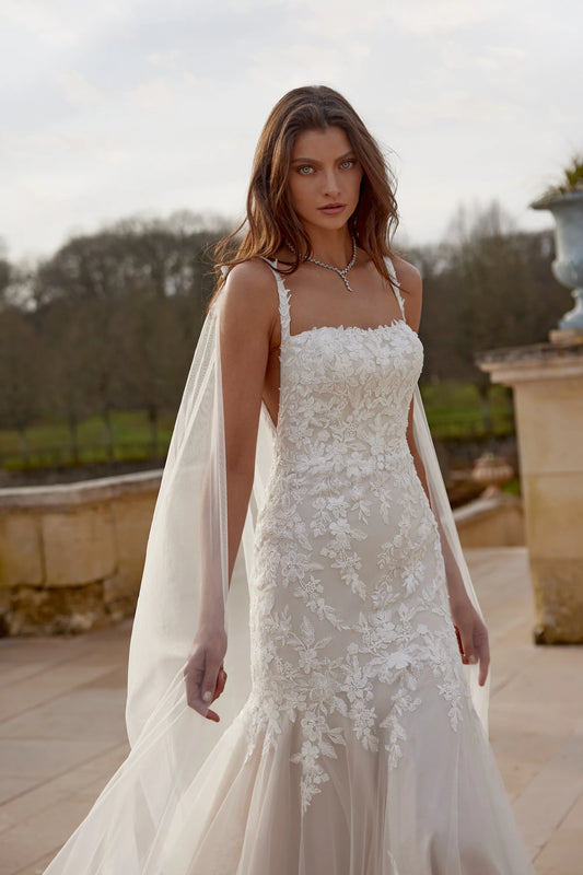 XAYWEAR wedding dress with floral lace detailing and sheer train on model outdoors