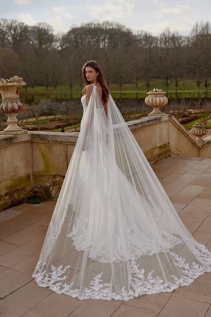 XAYWEAR wedding dress with long lace train and sheer flowing veil worn outdoors